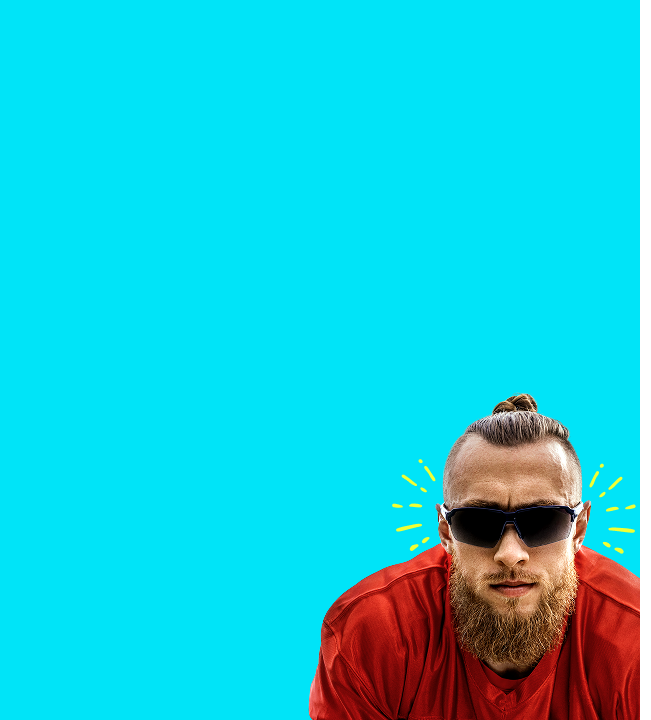 George Kittle in sunglasses, dressed in a red shirt, poses confidently against a bright aqua background with yellow accent lines.