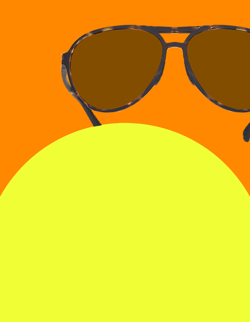 Close-up of tortoiseshell Zunnies Active Style sunglasses with light-adaptive lenses, on an orange and yellow background.