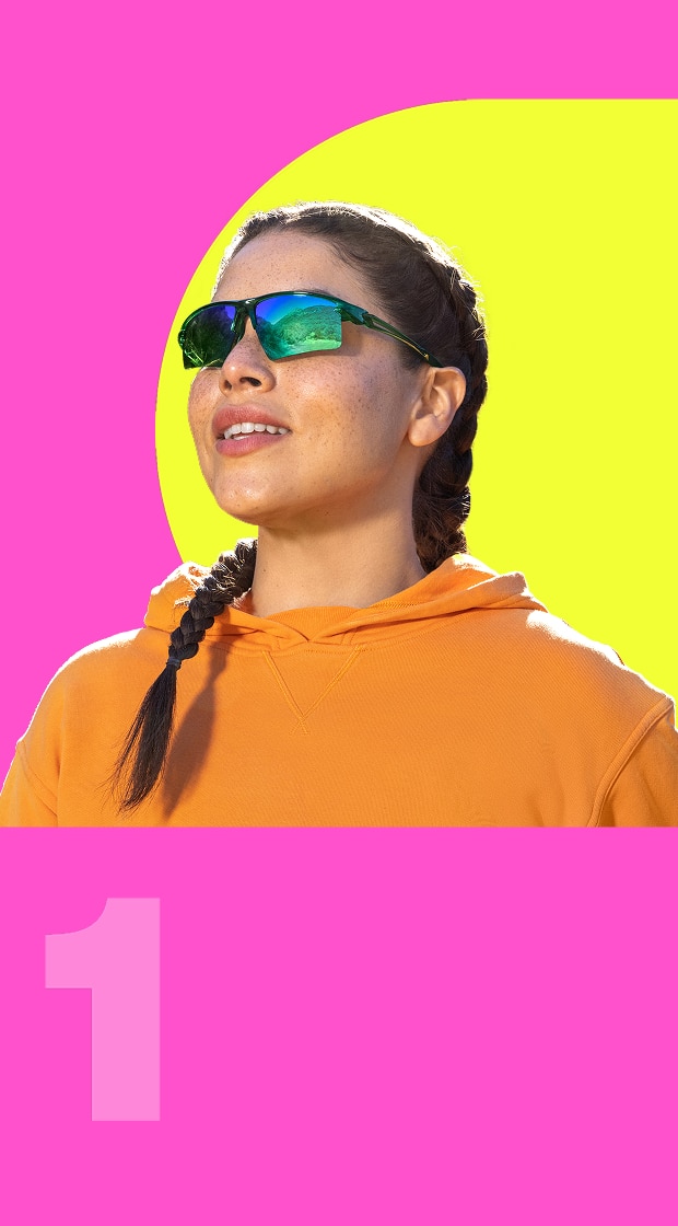 Zunnies sports sunglasses with classic tinted lenses against a pink and yellow background.