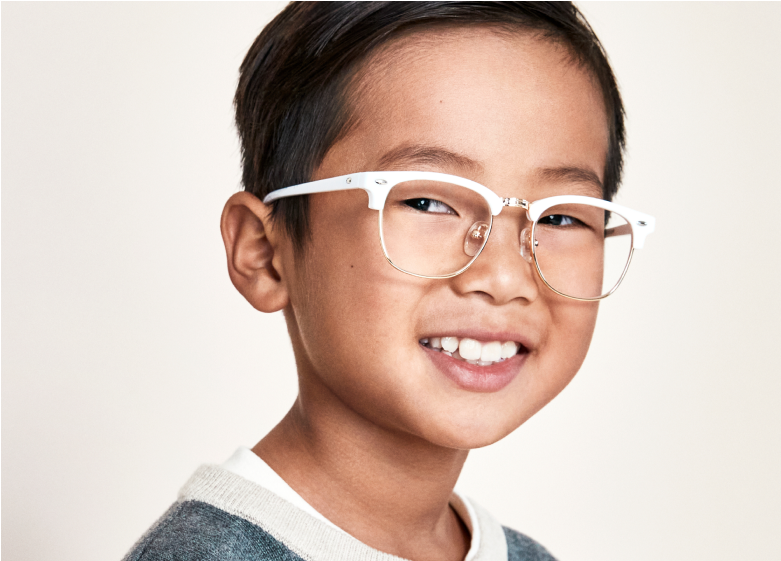 Image of a boy smiling, wearing Zenni white browline glasses.
