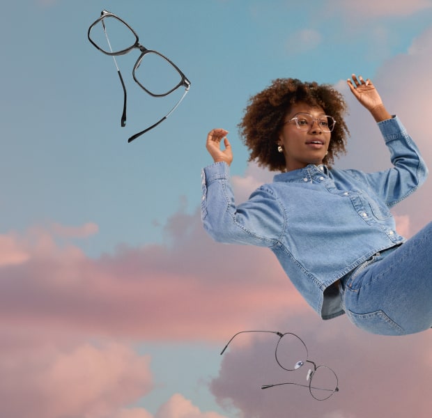 A woman with curly brown hair wearing lightweight geometric glasses, floating in a semi-reclined position in front of a background of pink clouds and blue sky. More pairs of lightweight glasses are floating around her.