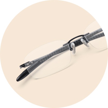 Image of Zenni titanium rimless glasses #138521 on a beige background.