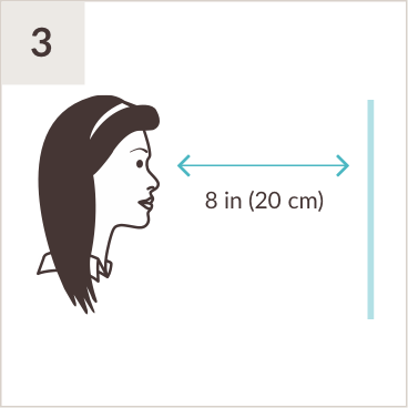 Illustration of woman facing a mirror eight inches away.