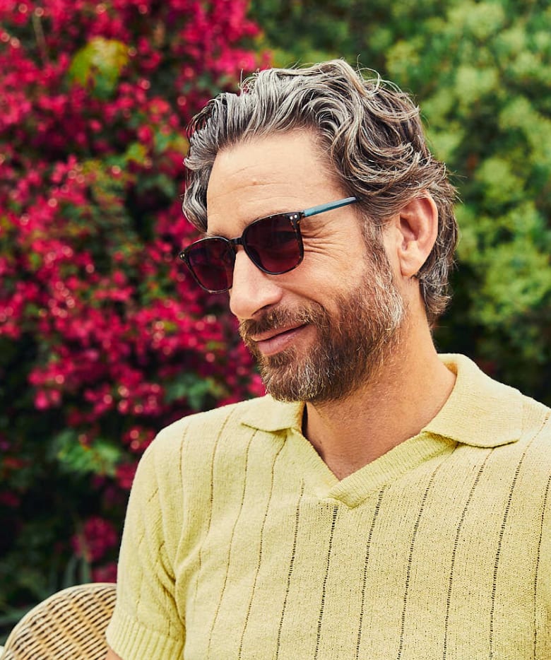 Man outdoors wearing Zenni Migraine Glasses for Light Sensitivity