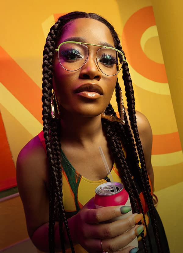 Keke Palmer wearing a pair of aviator frames from the "Summer Love" collection, part of the Keke Palmer x Zenni frame collaboration.