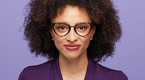Virtual Try-On image of woman in purple top against a purple background.