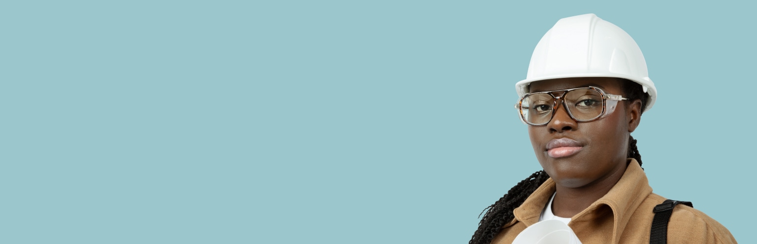 A black woman wearing tortoiseshell Zenni safety glasses and a white hard hat.