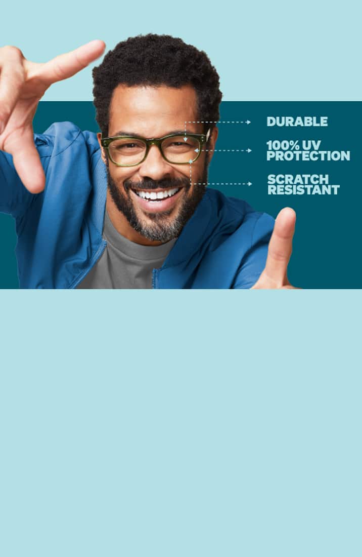 A man with short curly hair and a beard wearing readers glasses smiles at the camera. He is holding his hands up as if framing a picture. Beside him, text reads 'Durable', '100% UV Protection', and 'Scratch Resistant' with lines pointing to his glasses. The background is a light blue color.