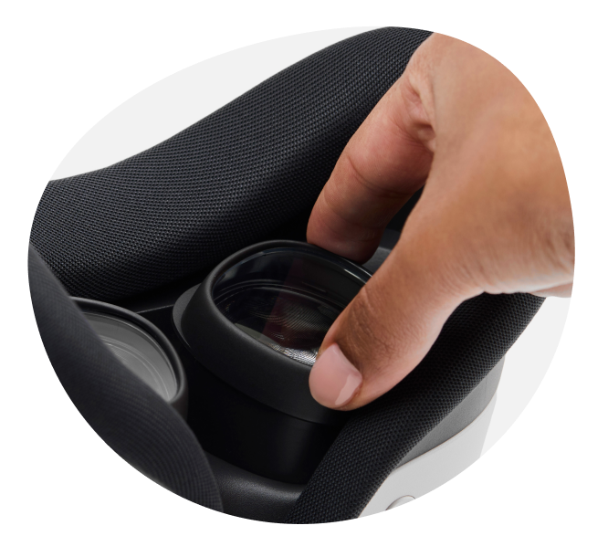 A hand inserting a Zenni VR lenst insert into a Meta Quest VR headset.