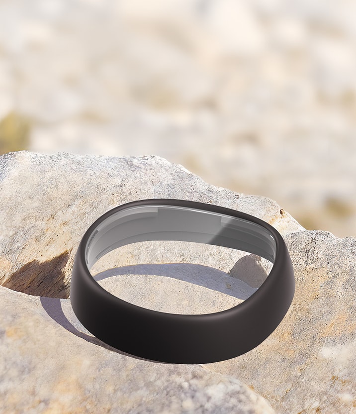 Zenni VR lens insert with scratch-resistant coating resting on a rock, highlighting durability against scratches and abrasions.