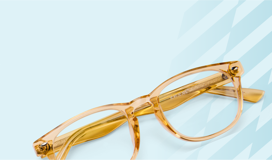 Translucent yellow glasses in front of a light blue confetti background with Zenni 22-year birthday logo and tagline, Eyewear for Everyone.