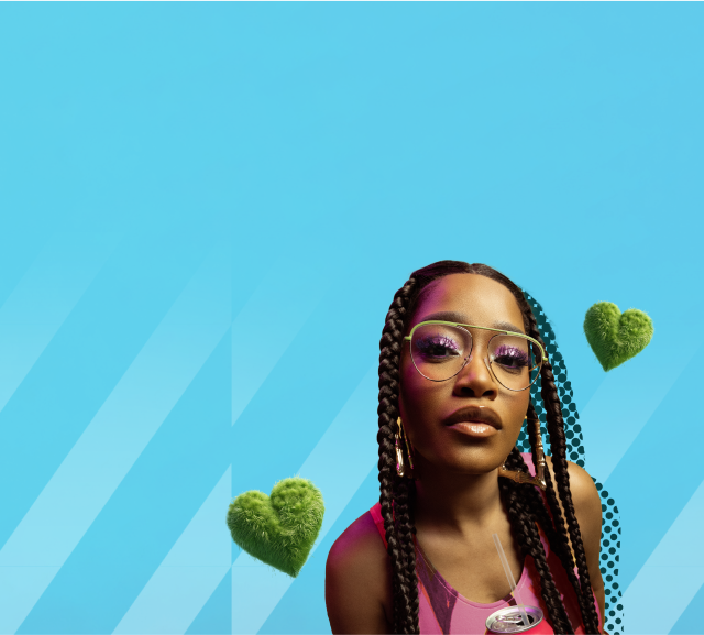 Close-up of Keke Palmer with her hair in long braids wearing large Zenni aviator glasses.