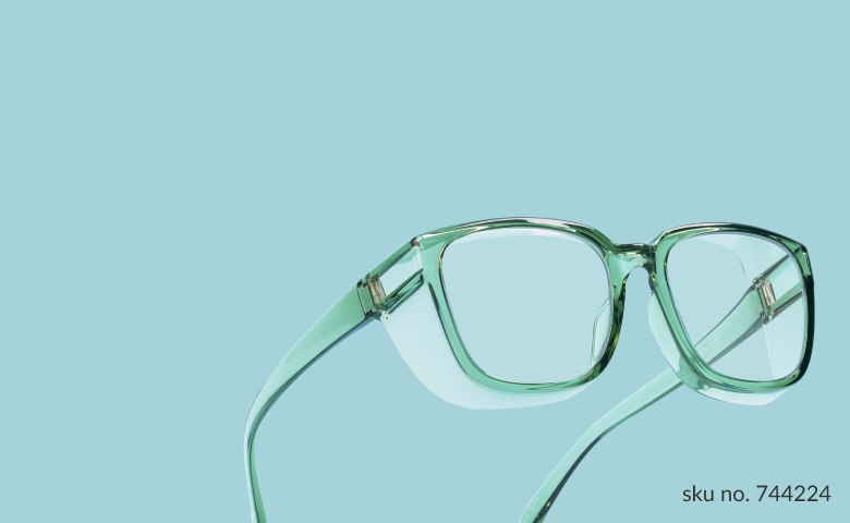 Light green transparent frame protective glasses on a light blue background.