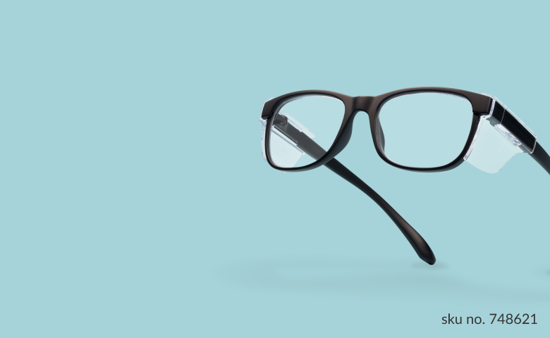 Black Zenni safety glasses with clear side shields on a light blue background.